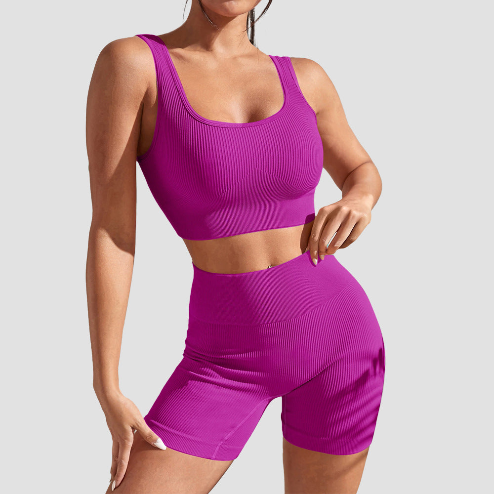 Pink sports bra and shorts set with high waist support for yoga and gym