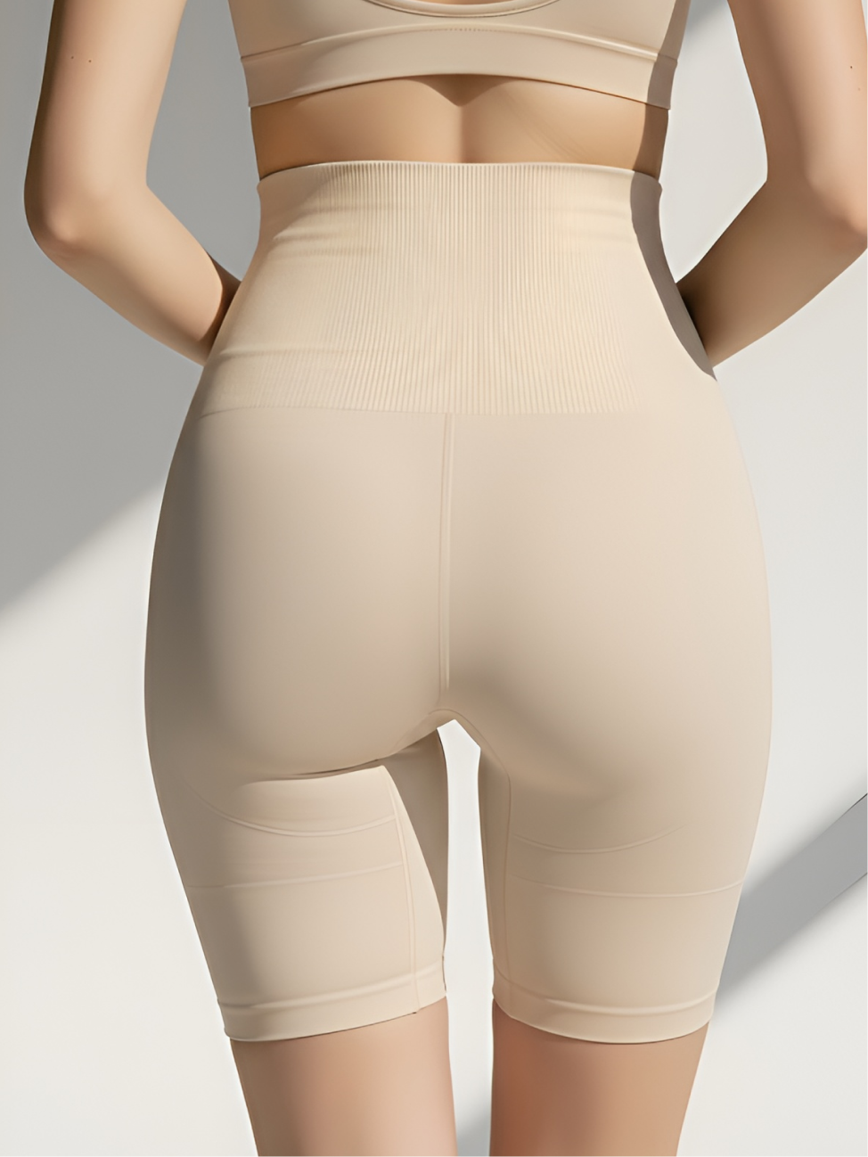 Back view of nude high-waist tummy control shorts with smoothing support and lift effect