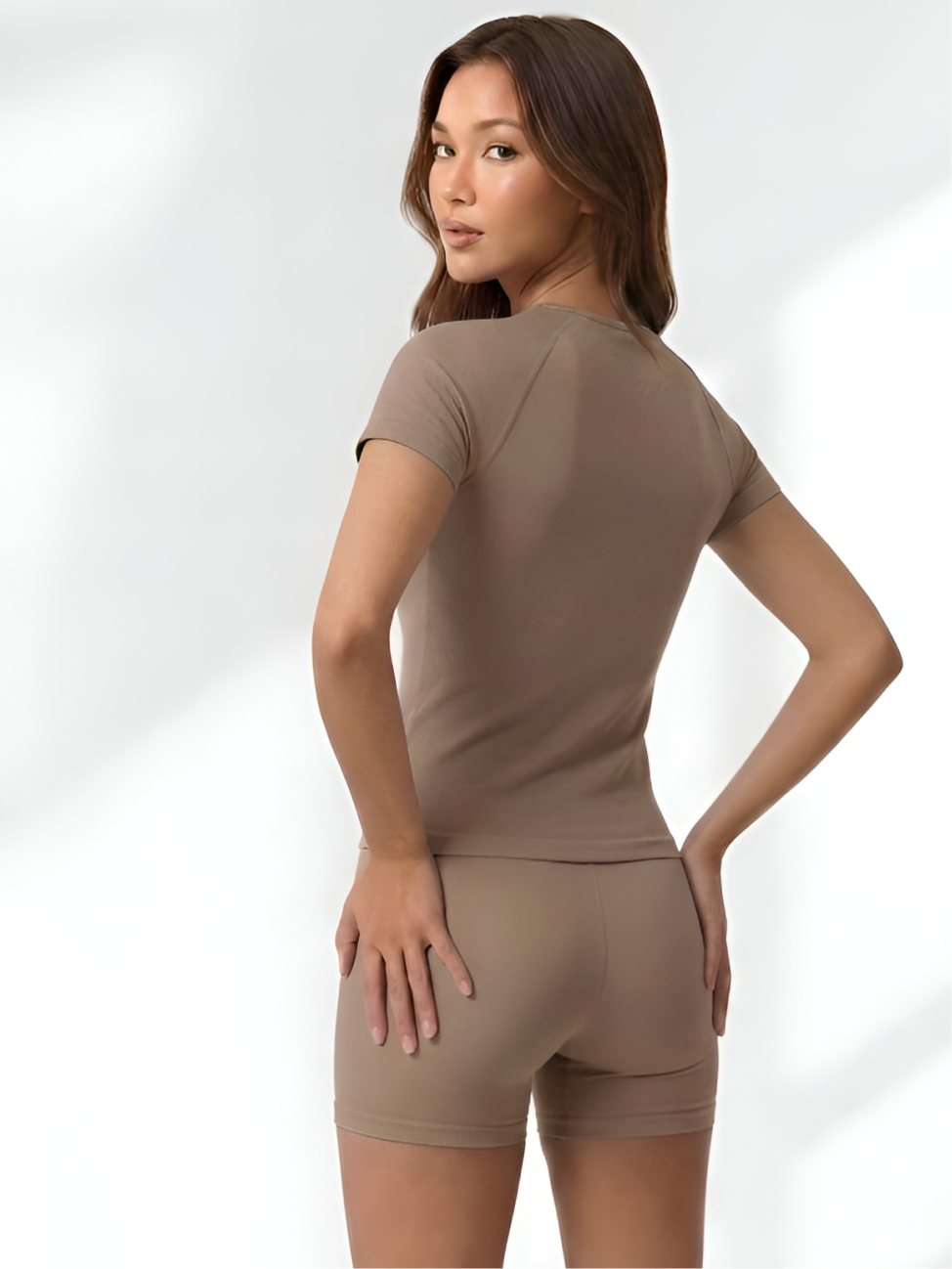 Back view of apricot yoga wear set with fitted short sleeve top and shorts