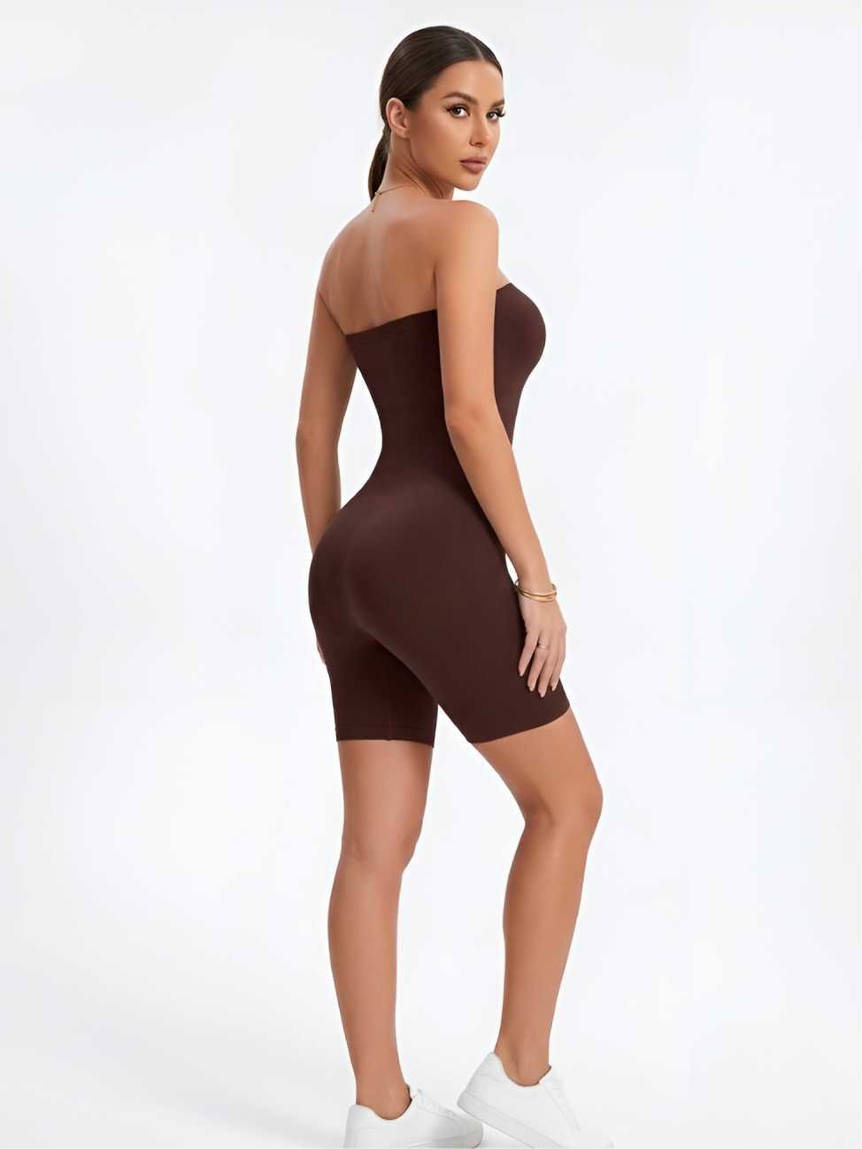 Back angled view of brown strapless shorts shaper with seamless waist and hip shaping