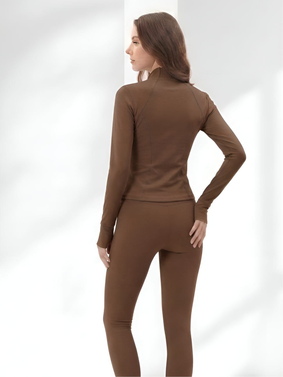 Back view of brown yoga wear set with stretch leggings and fitted jacket
