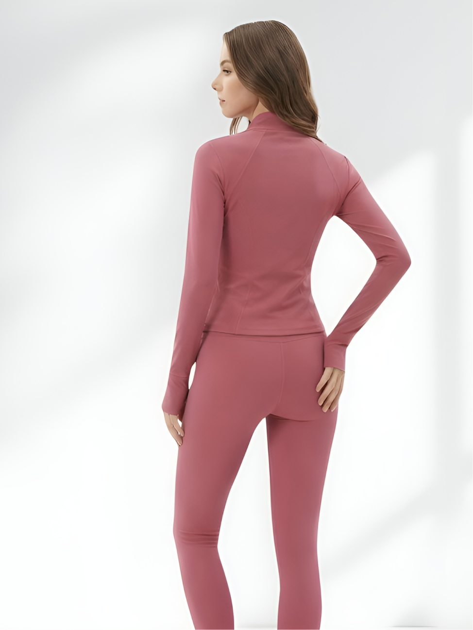 Back view of pink yoga wear set with stretch leggings and fitted jacket